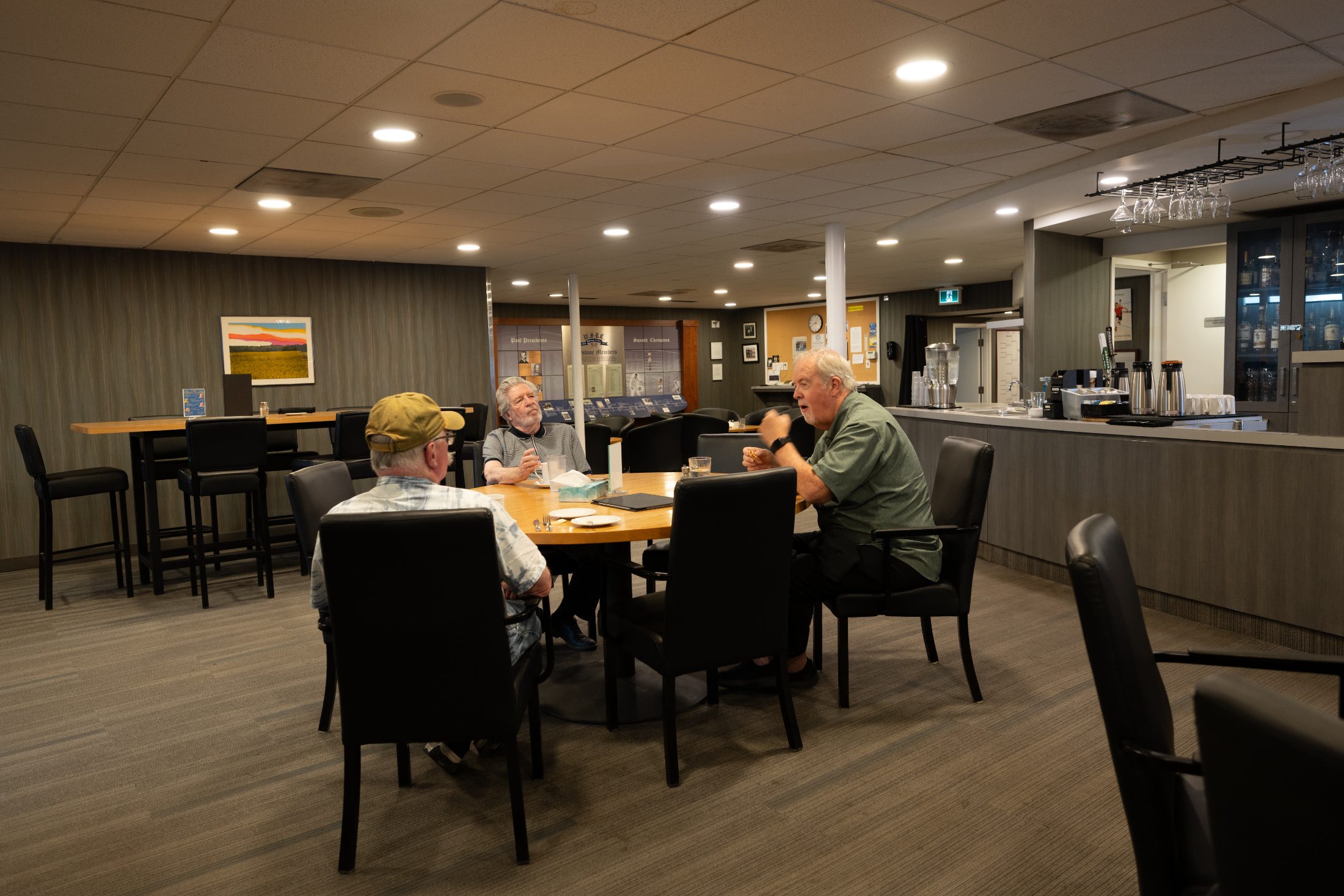 Members gathered around a familiar table in the Hopwood Lounge at the Winnipeg Squash Racquet Club