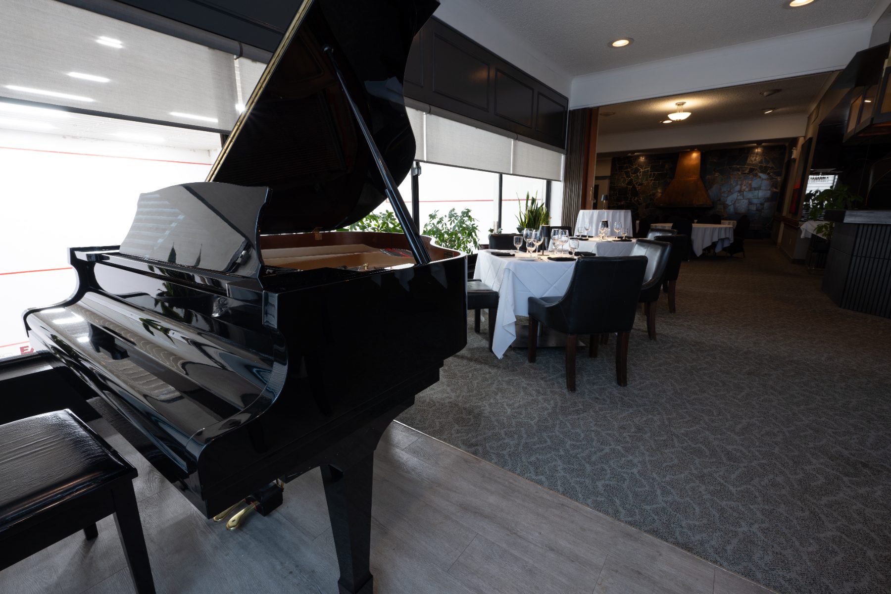 The baby grand piano beside the dining room