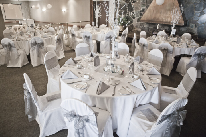 Beautiful table settings in front of copper fireplace for wedding held at Winnipeg Squash Racquet Club